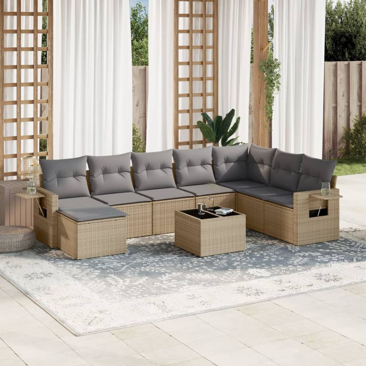 Outdoor-Korbmöbel-Set mit grauen Kissen, Couchtisch und Beistelltischen.