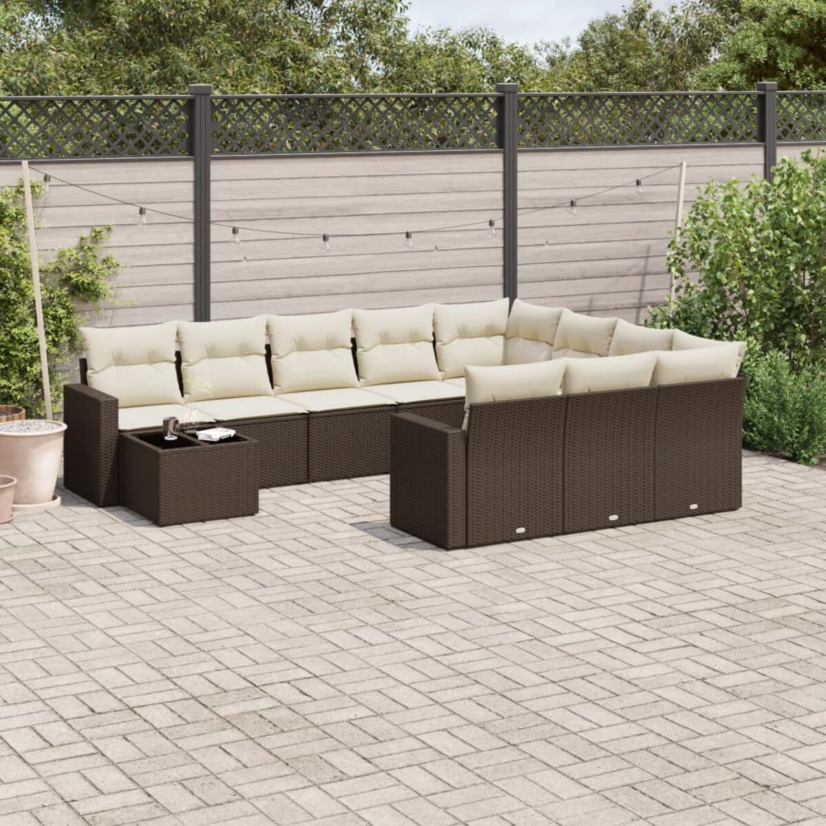 Set di mobili da esterno in vimini marrone con cuscini beige, tavolino.