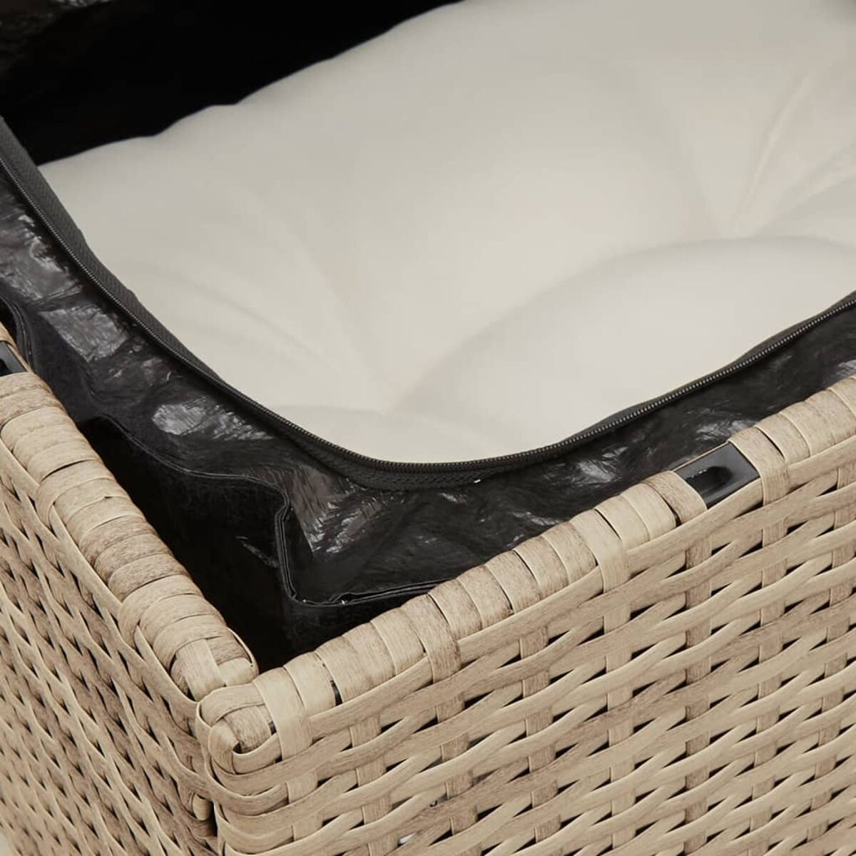 Nahaufnahme eines gewebten Aufbewahrungsbehälters aus Rattan mit schwarzem Reißverschluss und weißem Kissen.