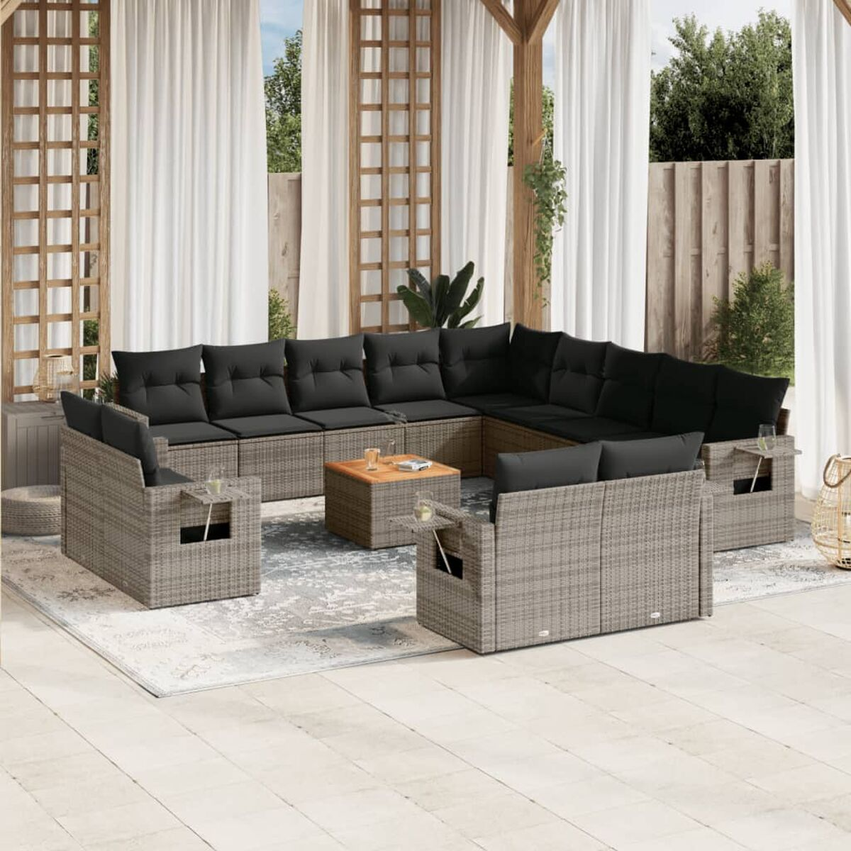 Geflochtenes Sofaset mit grauen Kissen, Holztischen und Getränkehaltern auf Teppich.