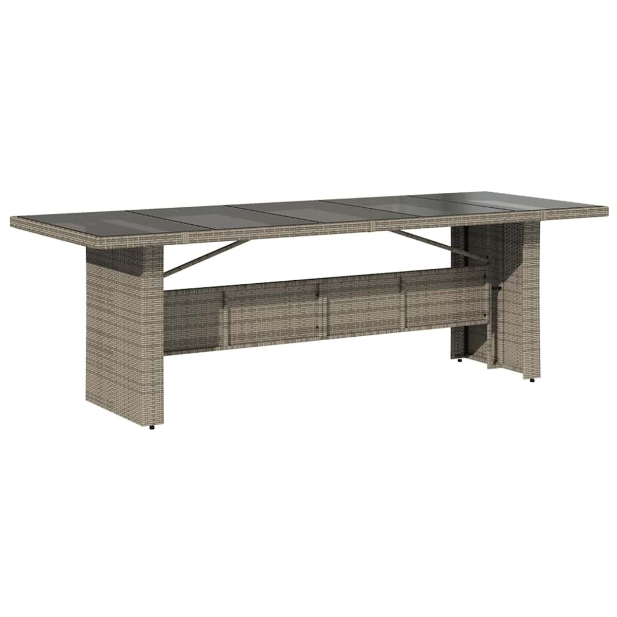 Tavolo da esterno in rattan con piano in vetro. Marrone chiaro, rettangolare, su un patio.