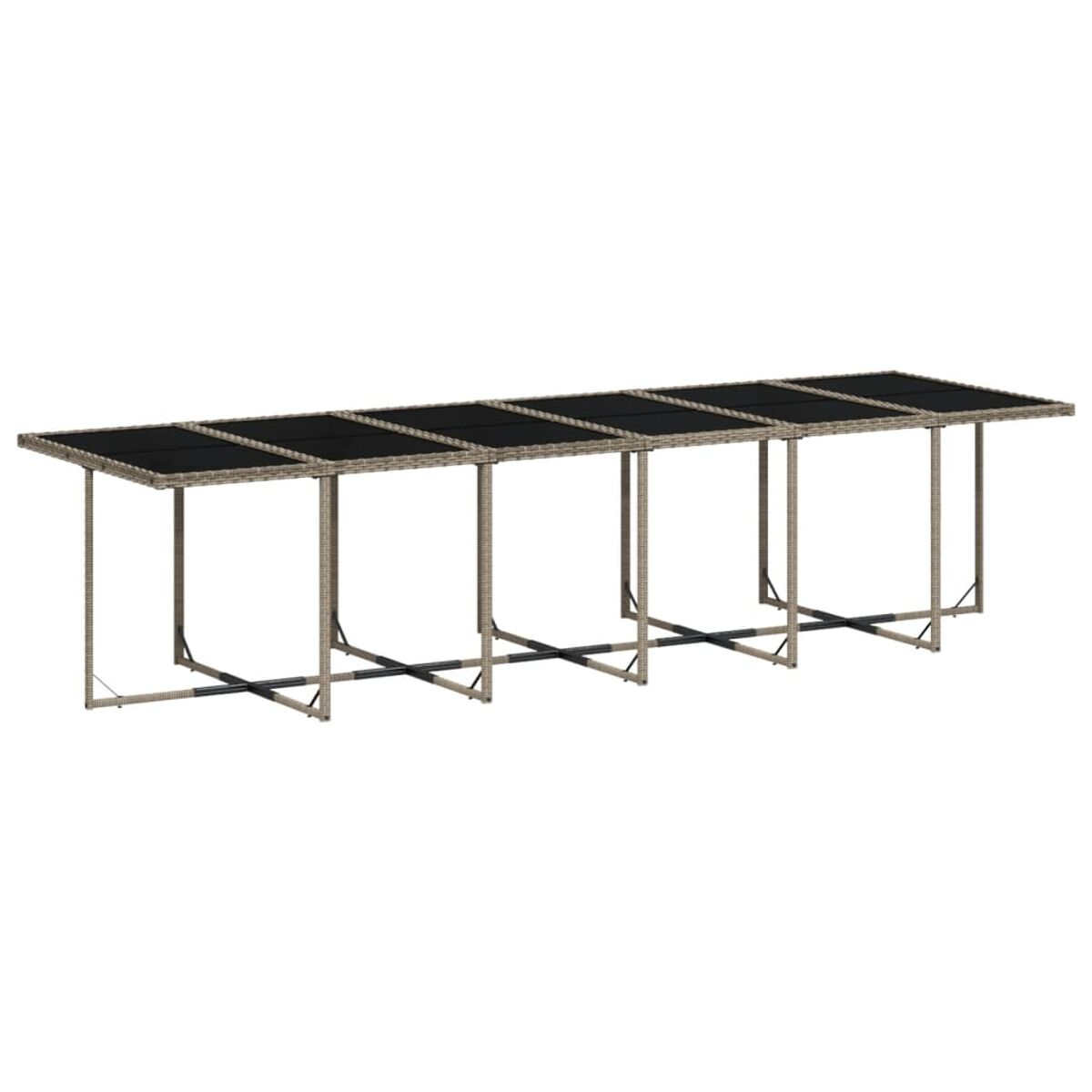 Un lungo tavolo con piano nero e struttura in rattan. Nessuna sedia visibile.