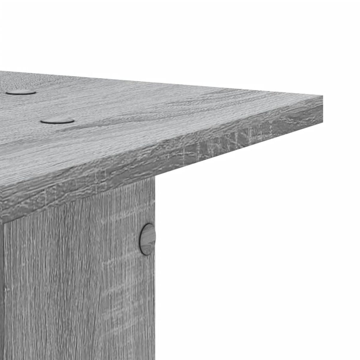 Nahaufnahme einer grauen Holztischecke. Zeigt die Maserung.