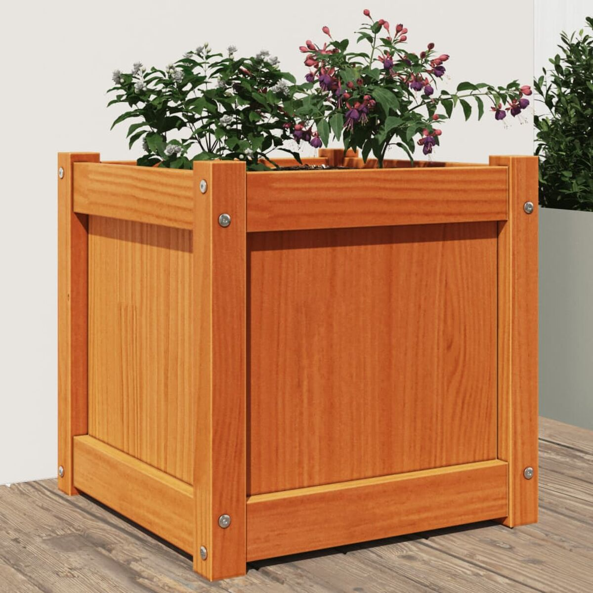 Pflanzkasten aus Holz mit Pflanzen. Er ist quadratisch. Das Holz hat eine hellbraune Farbe.