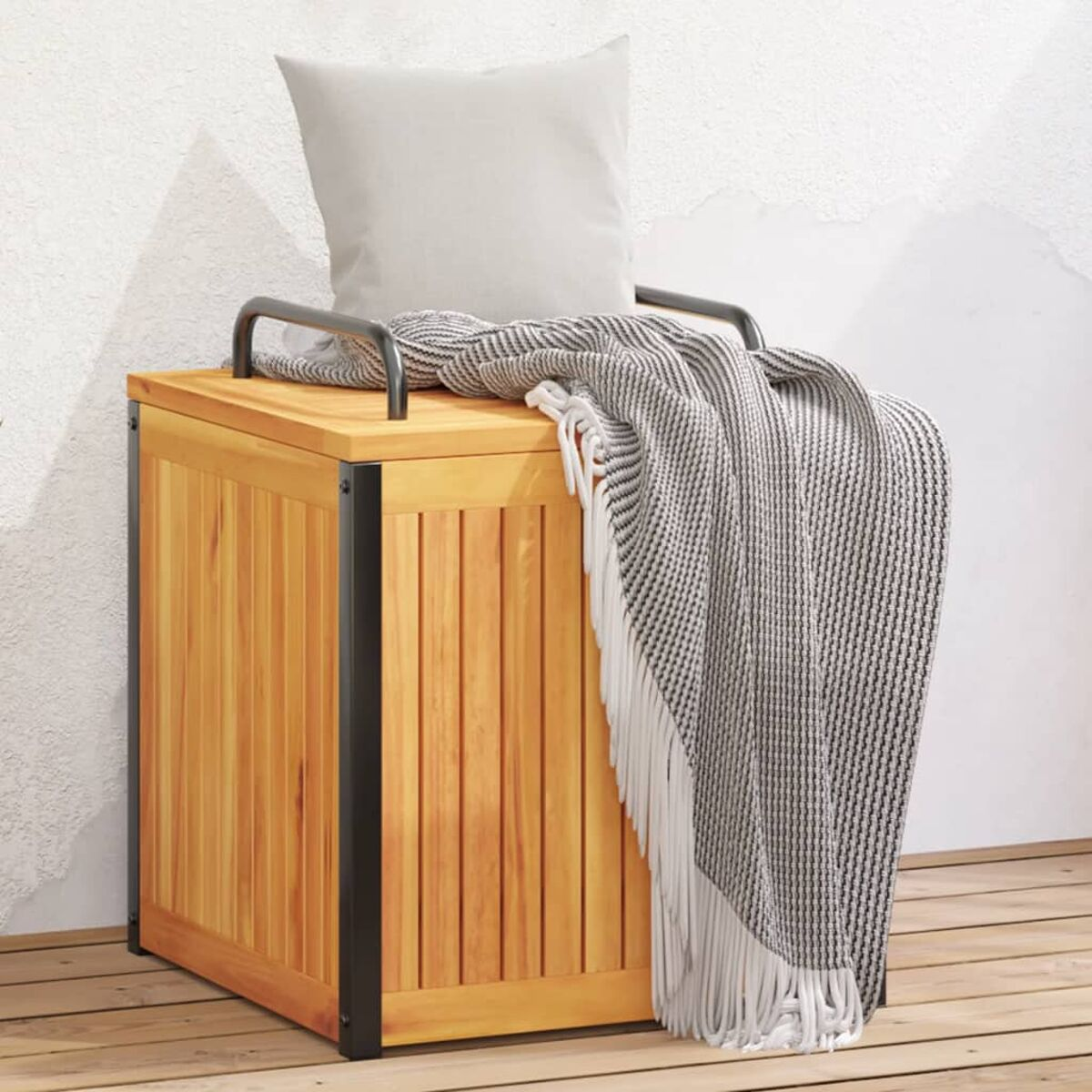 Eine Holzkiste mit Decke und Kissen darauf. Die Kiste hat schwarze Metallakzente.