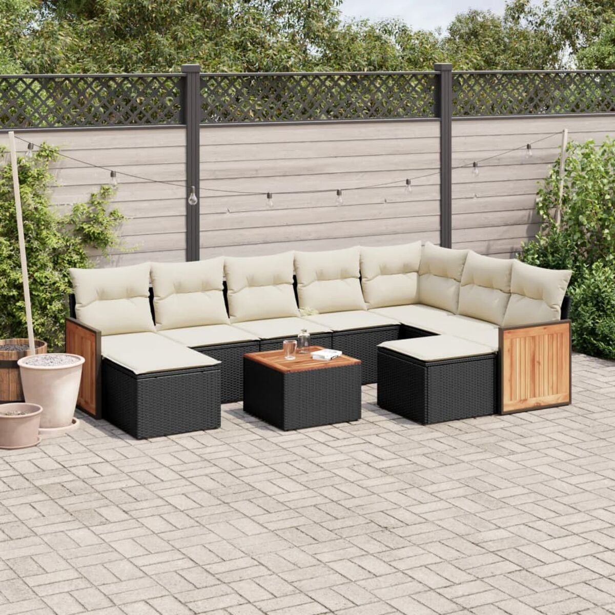 Outdoor-Szene mit schwarzem Korbmöbel-Set. Holzakzente und ein Holztisch.