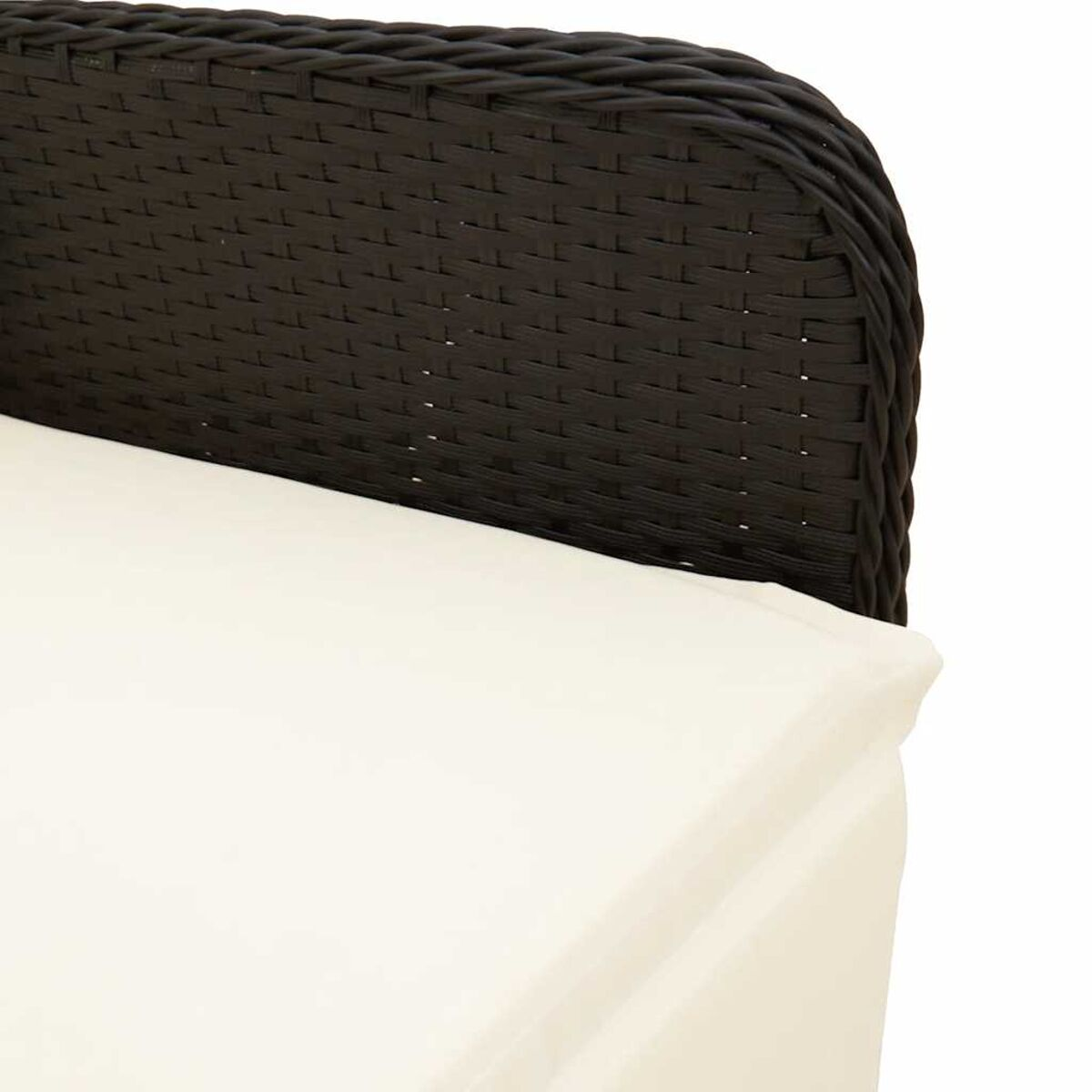 Primo piano dello schienale di una sedia in rattan nero con cuscino bianco, che mostra una texture intrecciata dettagliata.