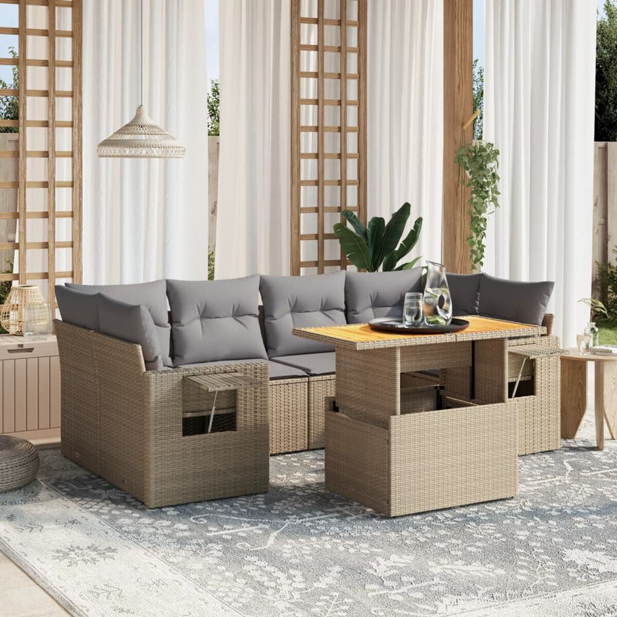 Set patio esterno con tavolo. Cuscini grigi su mobili in vimini. Una brocca e bicchieri sono sul tavolo.