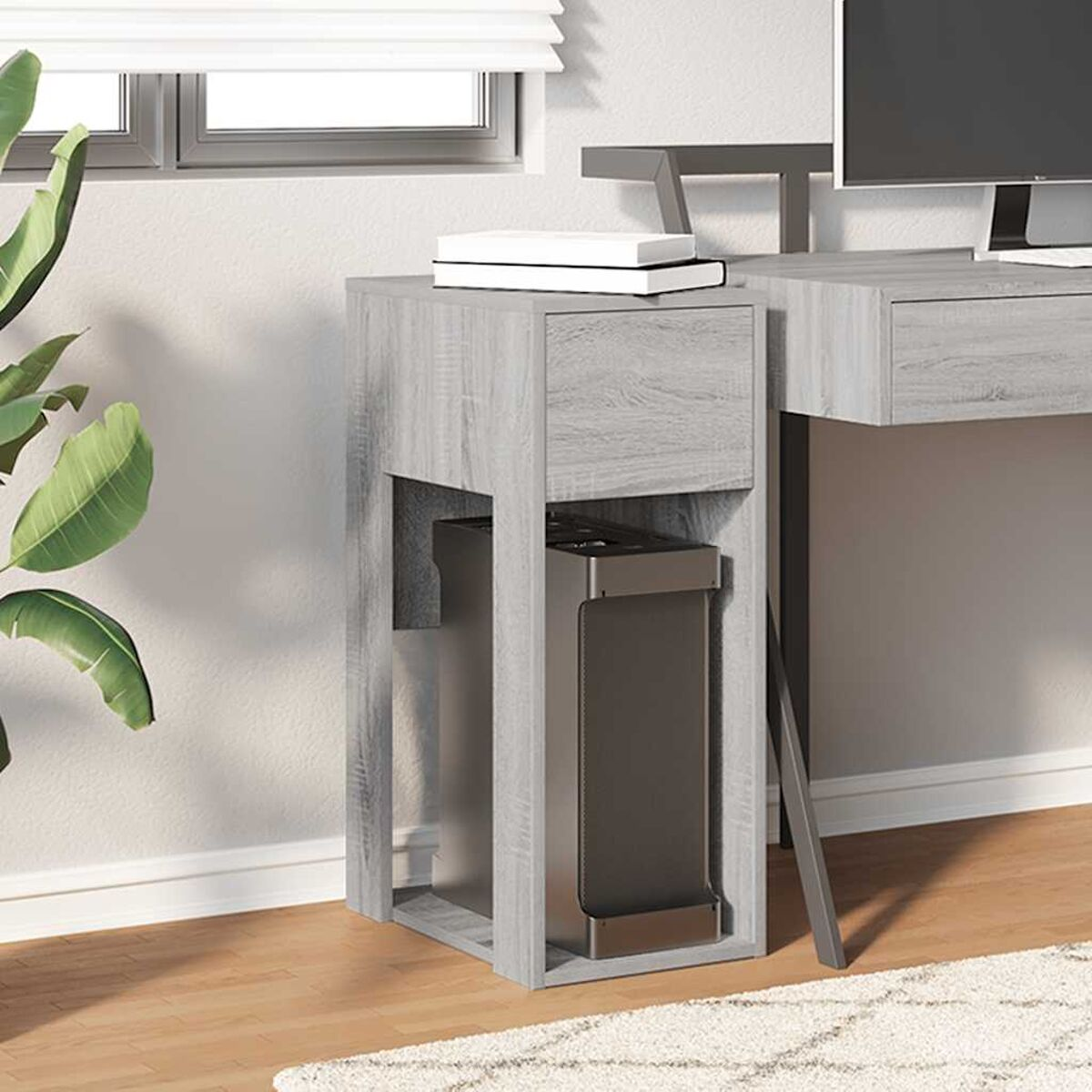 Grauer Schreibtisch mit Schublade und Platz für einen Computer-Tower. Holzboden.