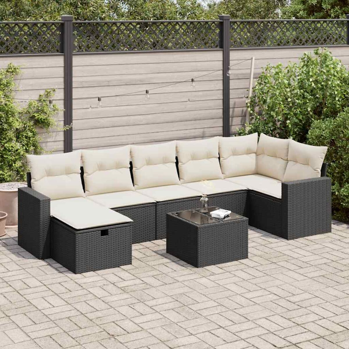 Schwarzes Rattan-Sofa-Set für den Außenbereich mit beigen Kissen. Ein quadratischer Tisch steht im Zentrum.