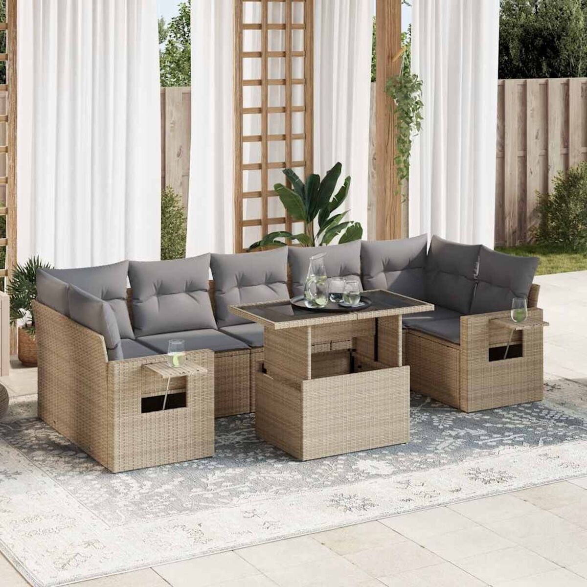 Mobili componibili per esterni: rattan beige con cuscini grigi, tavolino elevabile e bicchieri.
