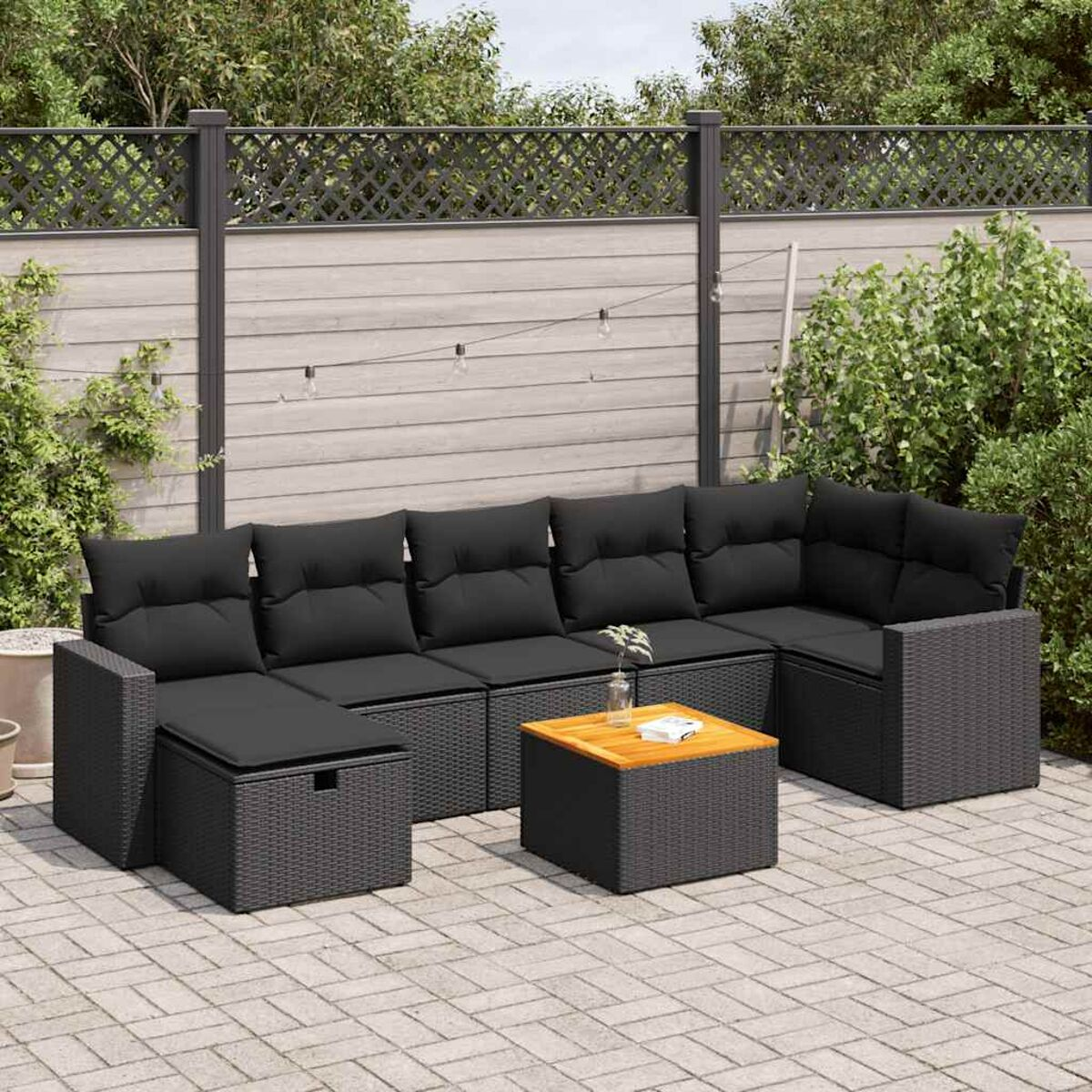 Ein Outdoor-Ecksofa mit Tisch und Kissen auf einer Terrasse.