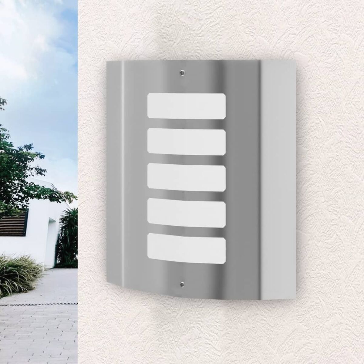 Ein silberner, wandmontierter Briefkasten mit rechteckigen weißen Schlitzen und einer hellen Wand.
