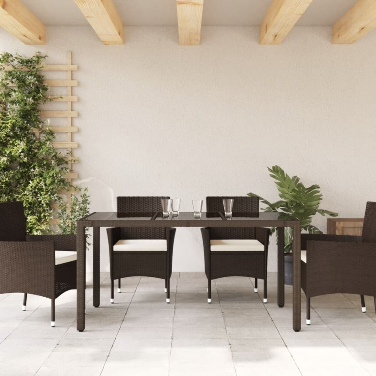 Essgruppe im Freien mit Tisch und vier Stühlen, mit Kissen. Die Szene ist eine Terrasse.
