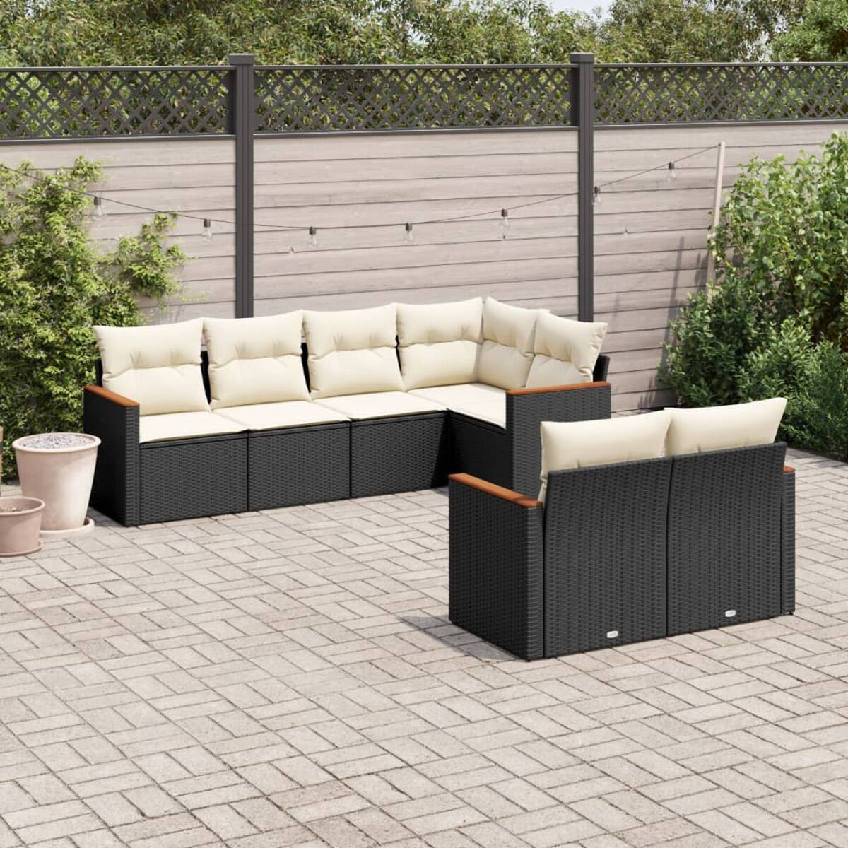 Outdoor-Sitzbereich mit Sofa und Stühlen. Die Umgebung befindet sich auf einer Terrasse.
