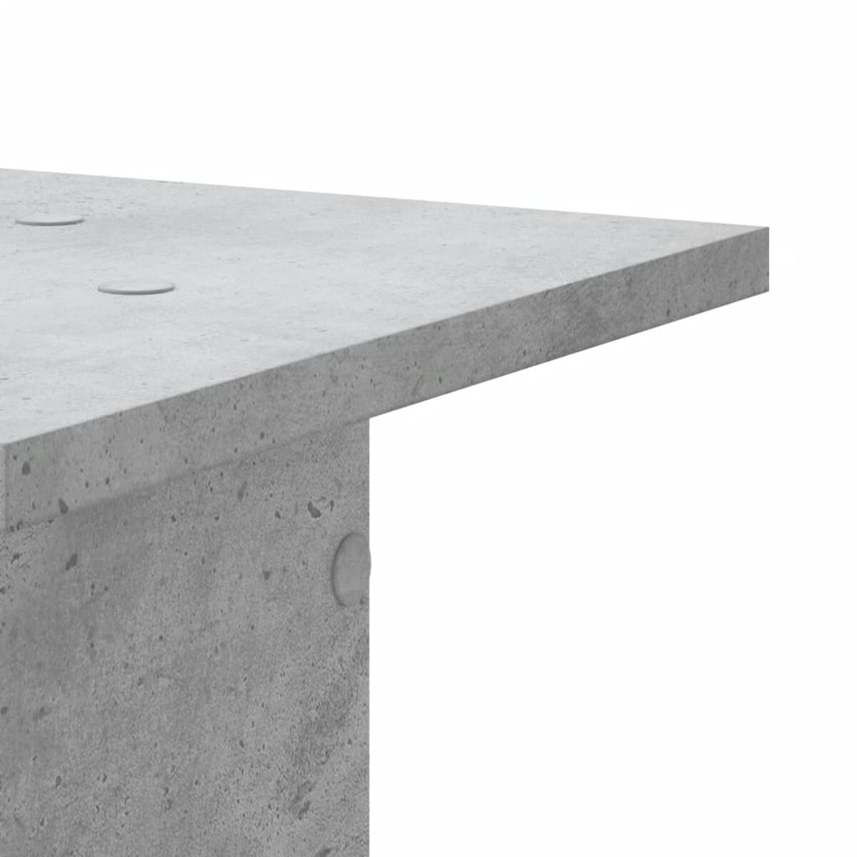 Nahaufnahme einer grauen Betonoberfläche mit drei kleinen kreisförmigen Vertiefungen.