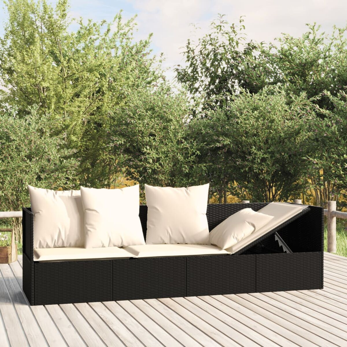 Schwarzes Rattansofa mit weißen Kissen. Das Sofa hat ein aufklappbares Staufach.