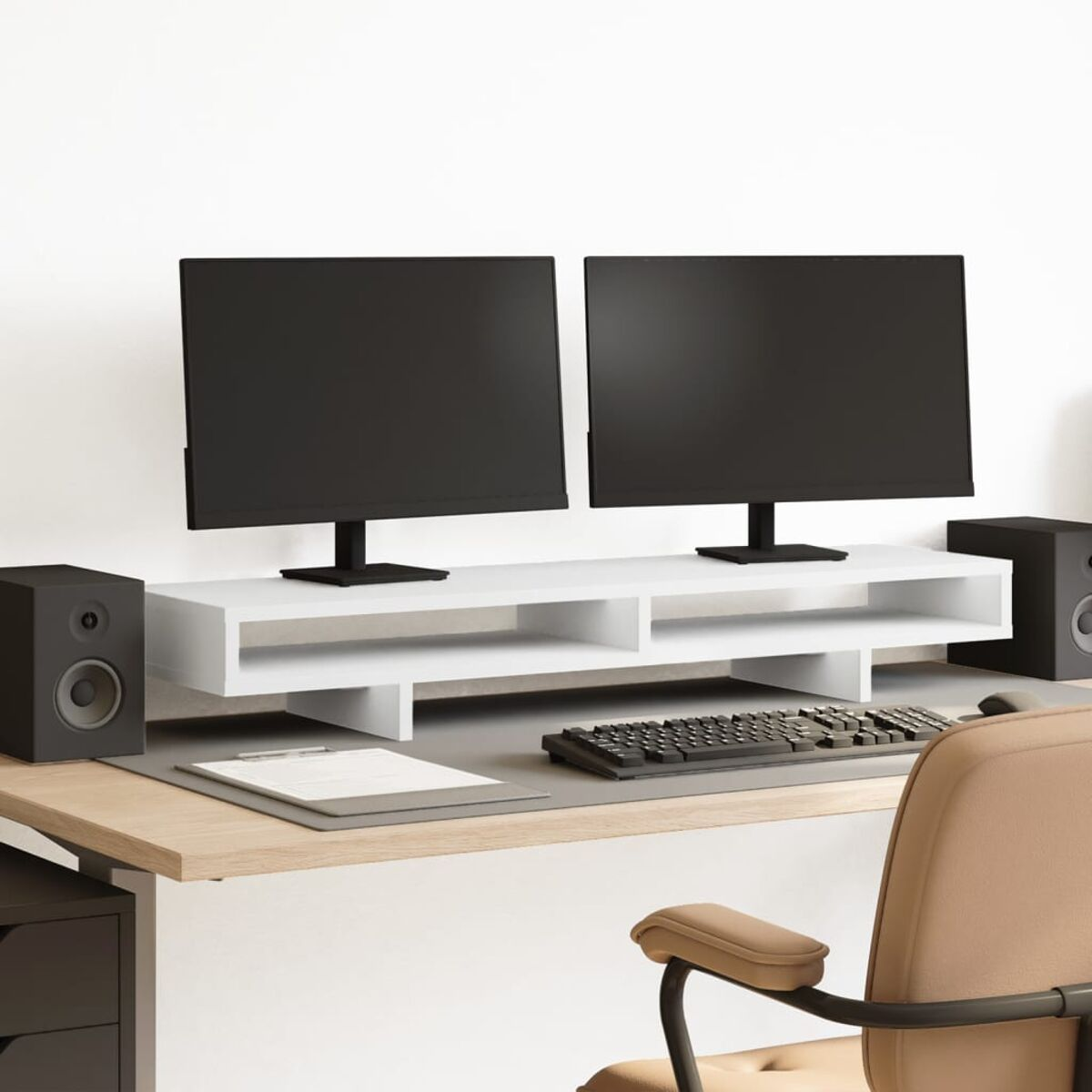 Schreibtisch-Setup mit zwei Monitoren, einem weißen Regal, Tastatur, Lautsprechern und einem beigen Stuhl.