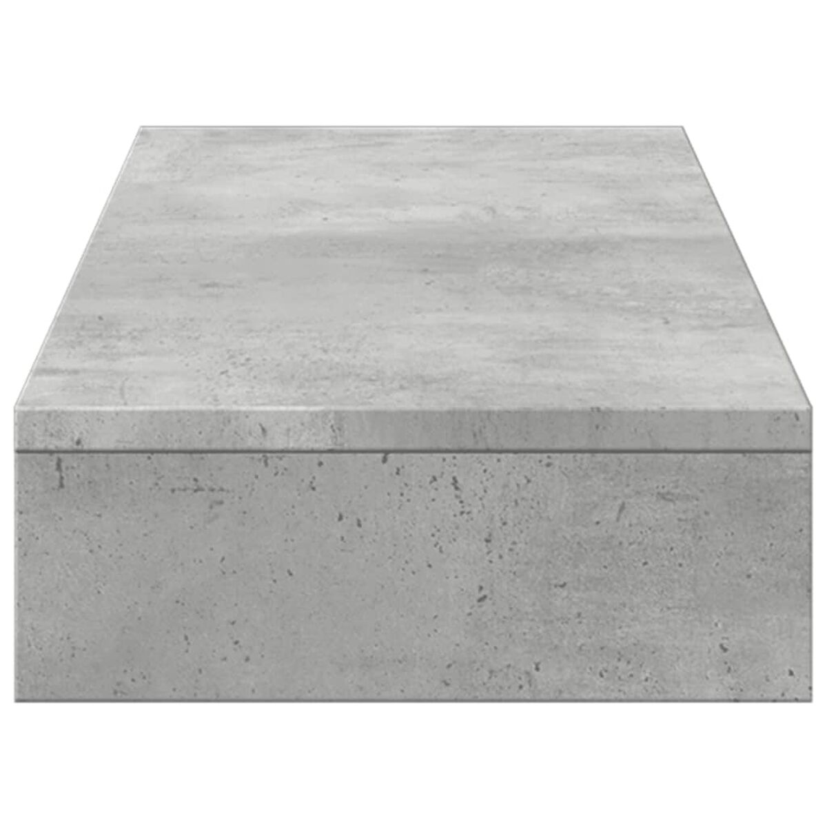 Nahaufnahme eines grauen Couchtisches aus Beton. Zeigt die Ober- und Seitenfläche.