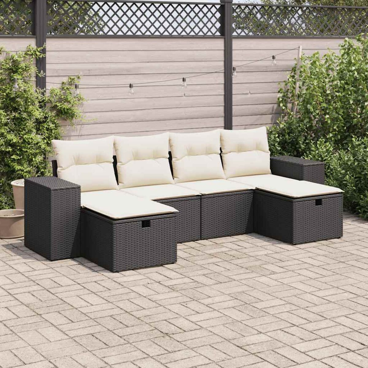 Ein schwarzes Outdoor-Ecksofa aus Korbgeflecht mit schwarzen Kissen und einem Beistelltisch.