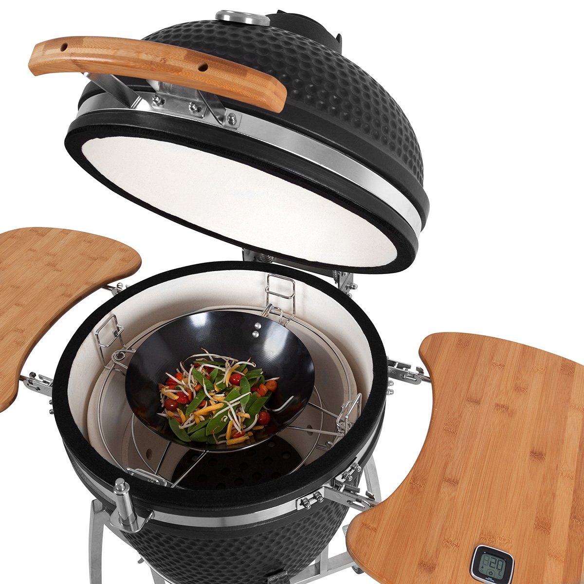 Black ceramic grill with a wooden handle and side tables, filled with vegetables.