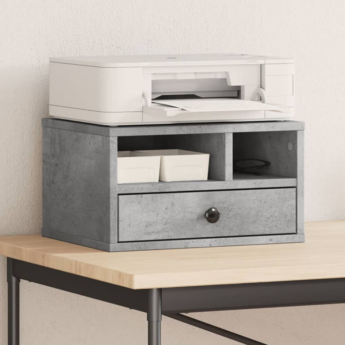 Drucker auf einem grauen Schrank mit Schublade. Zwei weiße Boxen in einem Fach.
