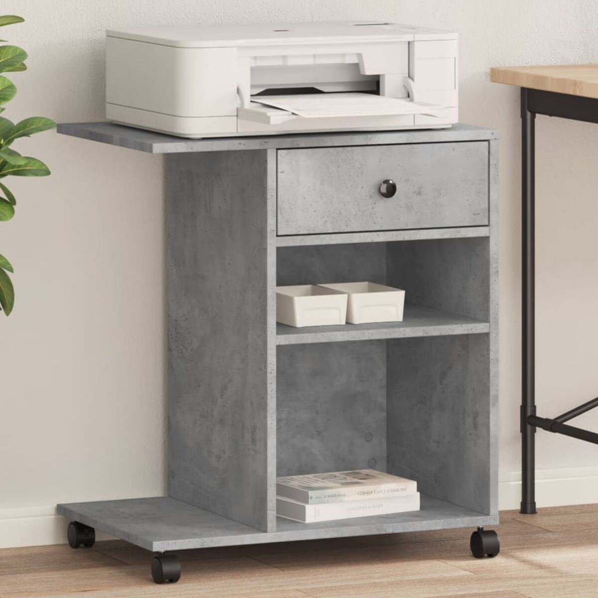 Ein grauer Druckerstand mit Drucker, Schublade, Regalen und Büchern wird gezeigt.