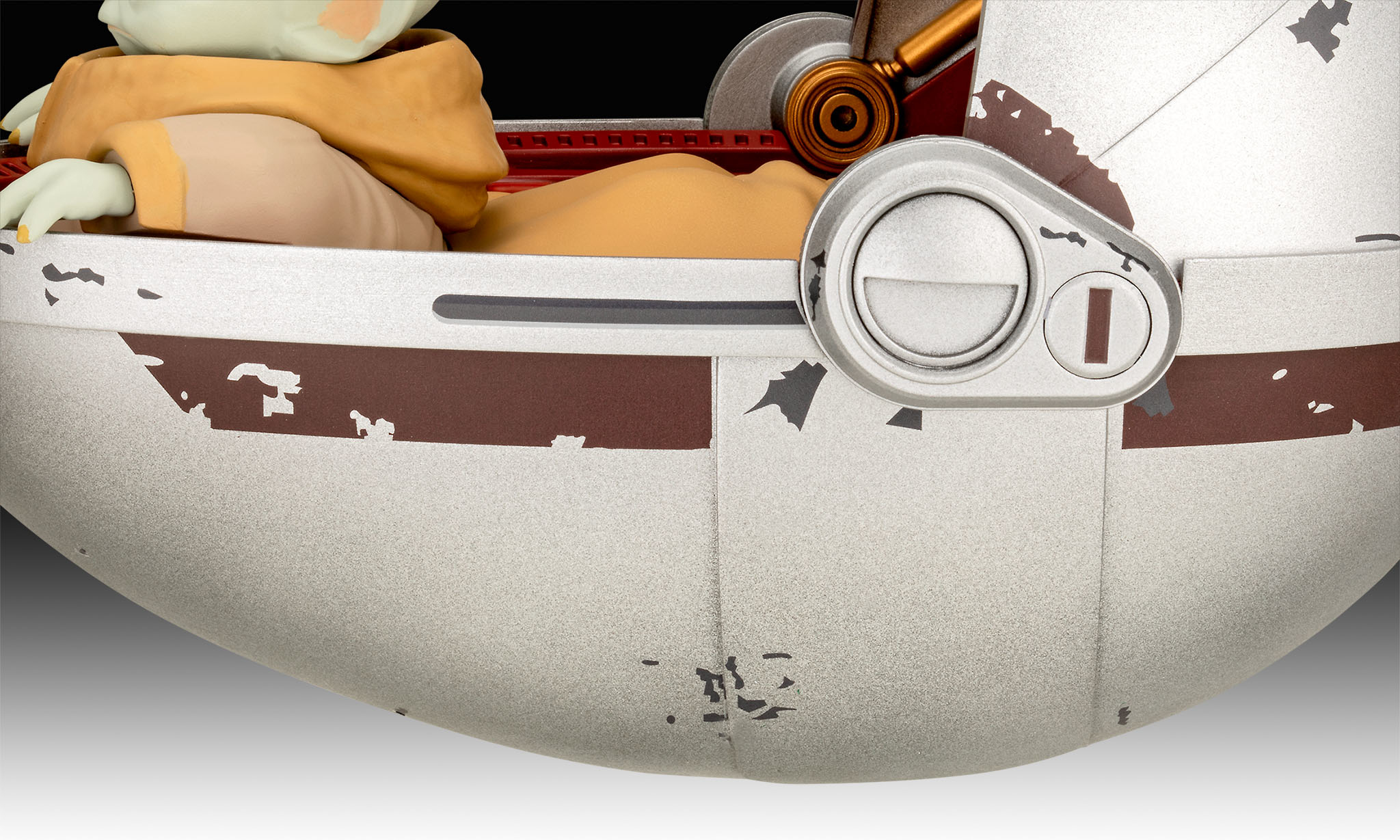 Close-up of Grogu's white and brown pram, showing detail and a metallic side panel.