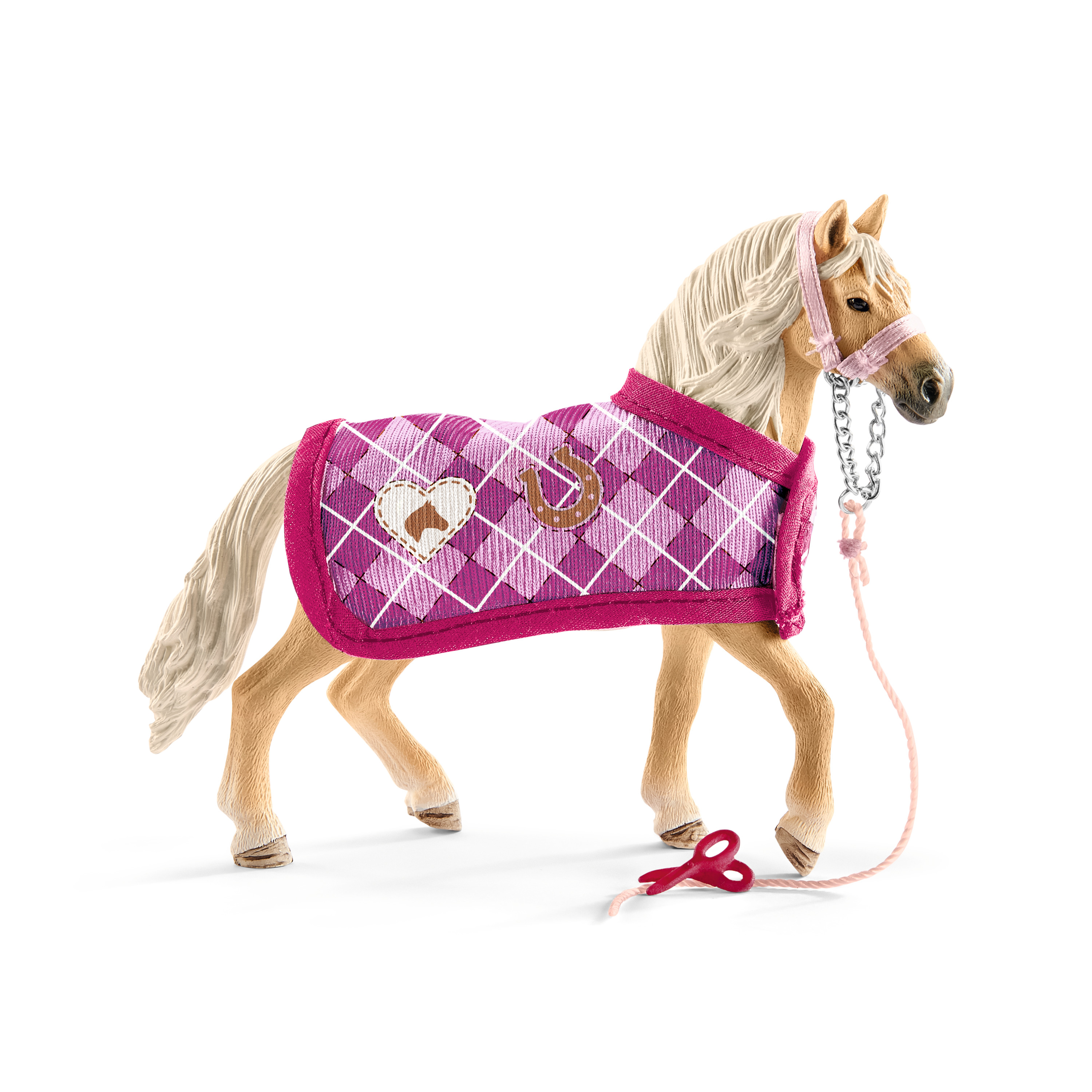 Cheval jouet beige avec couverture et bride roses.