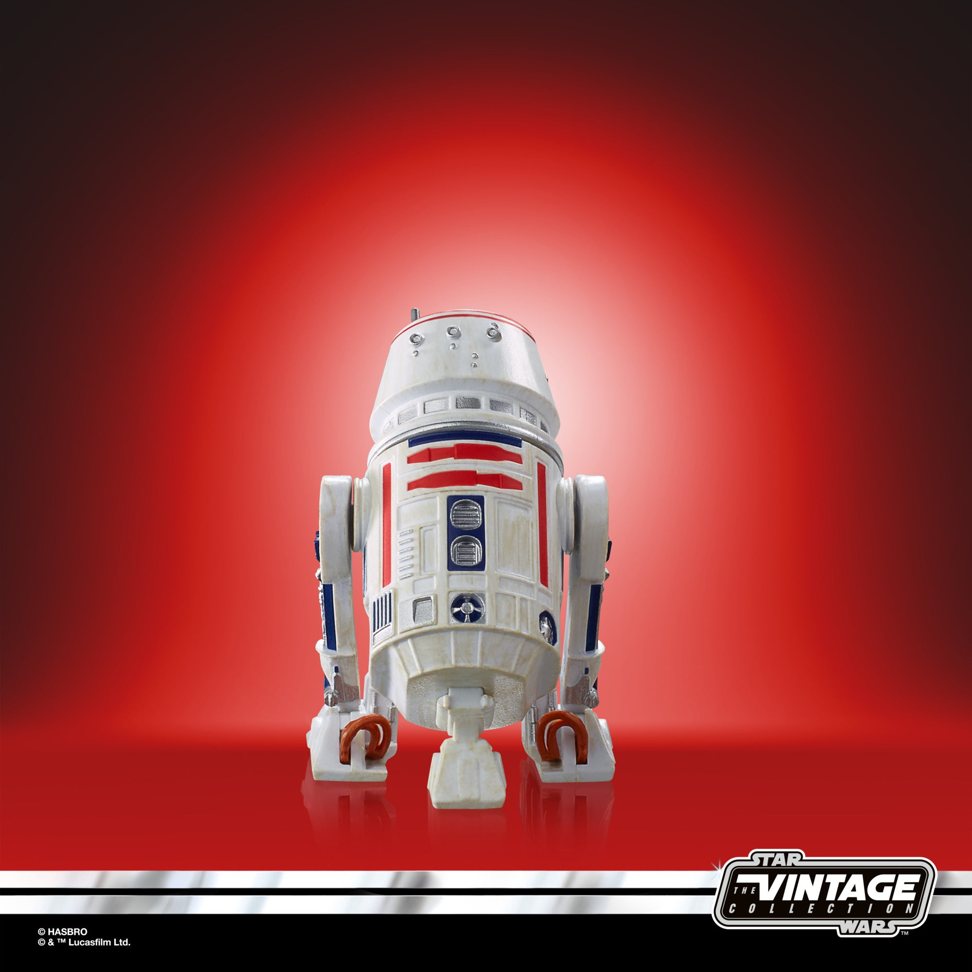 Figurka Star Wars R2-D2 na czerwonym tle. Robot jest zwrócony przodem.