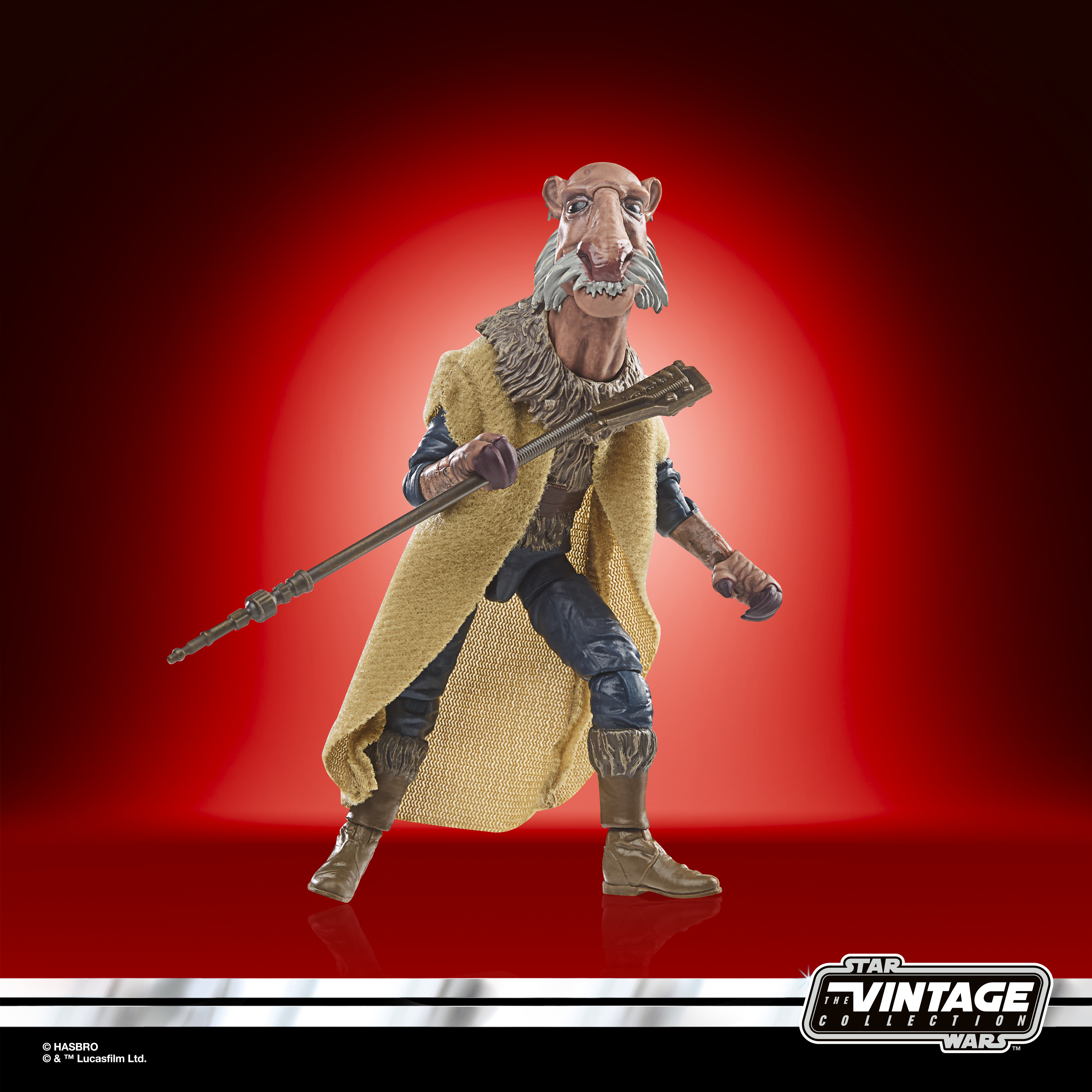 Una figura di Star Wars di un personaggio con un cappotto giallo e un bastone.