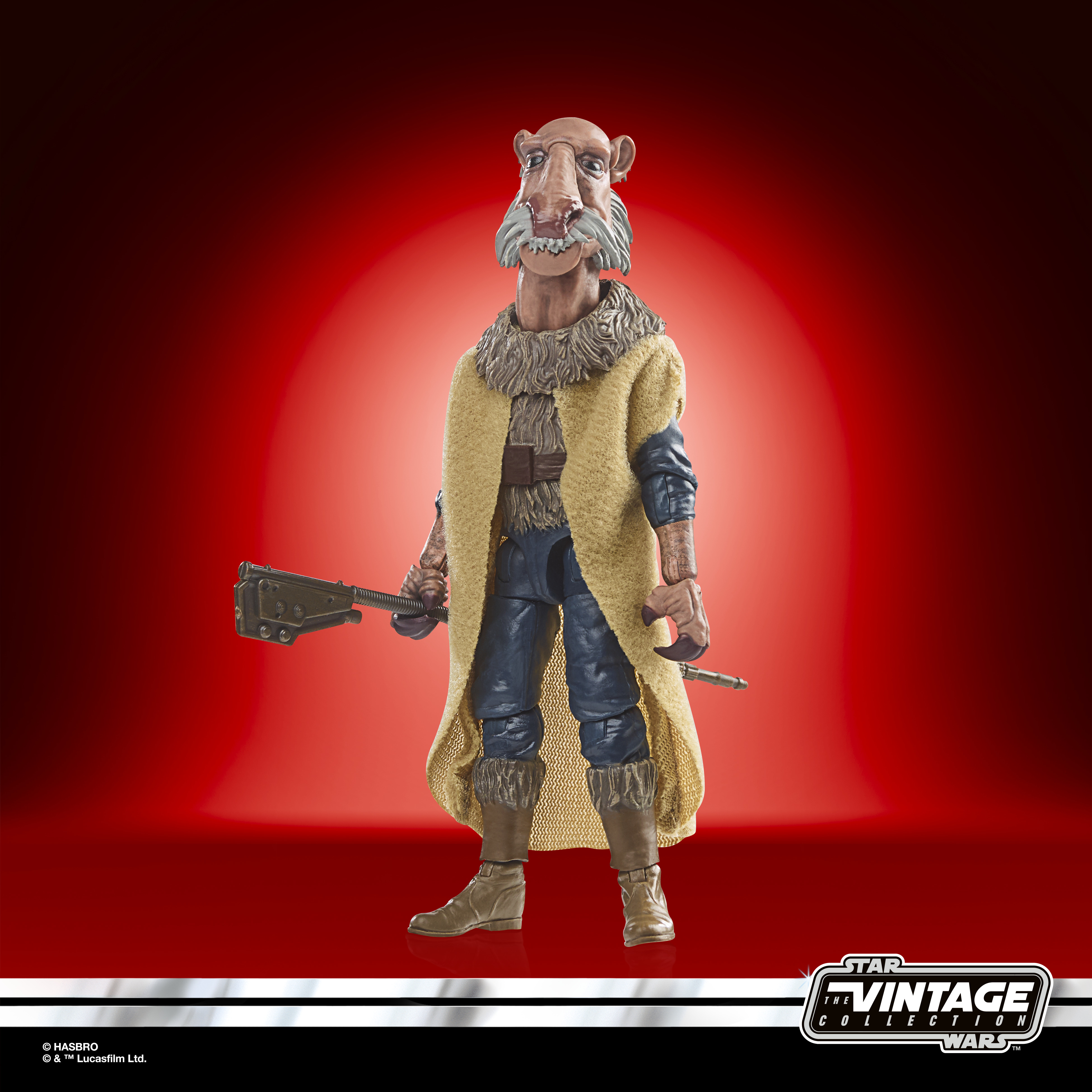Un'action figure aliena con un cappotto giallo e un'arma, su sfondo rosso.