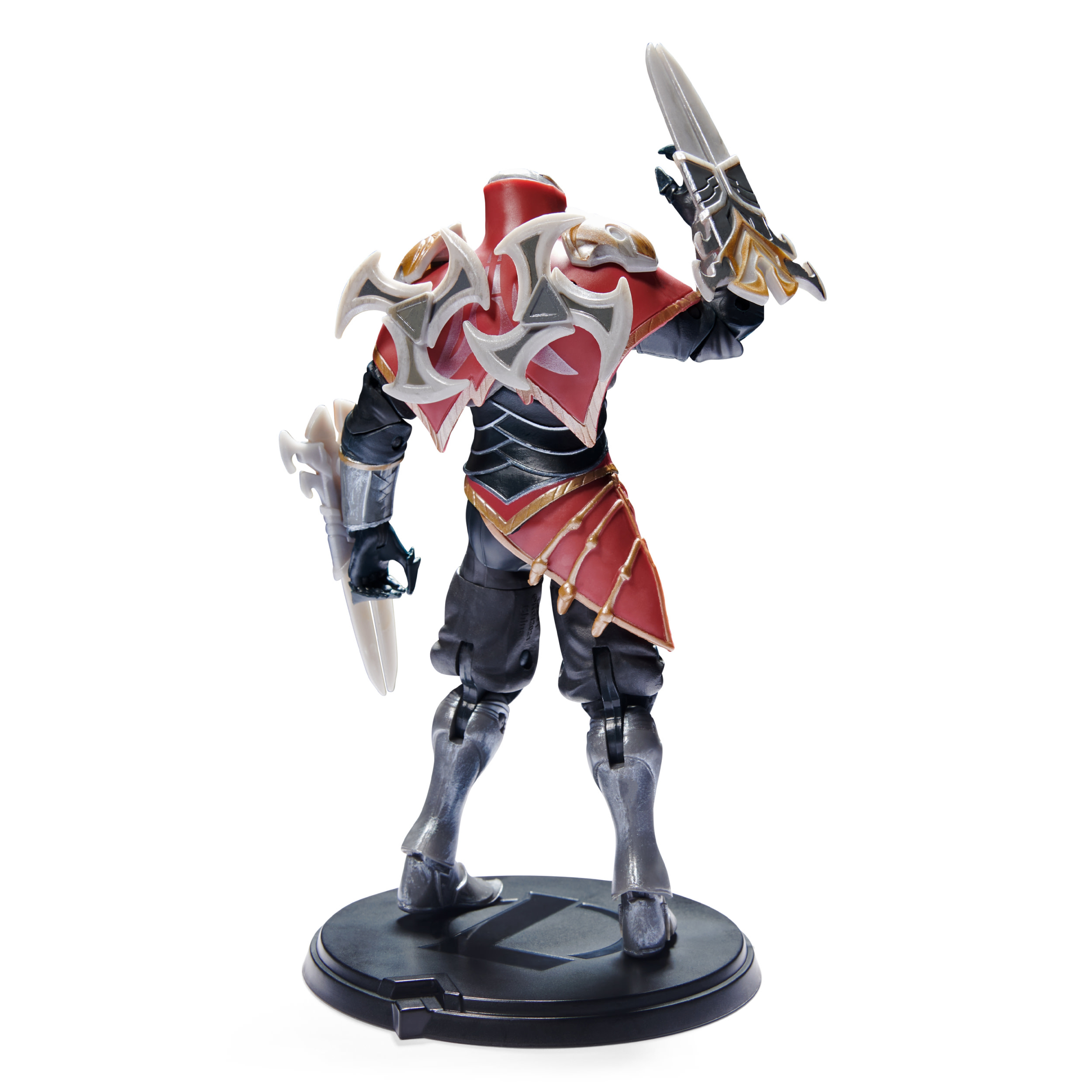 Actionfigur einer Figur in roter und schwarzer Rüstung mit einem Schwert. Weißer Hintergrund.