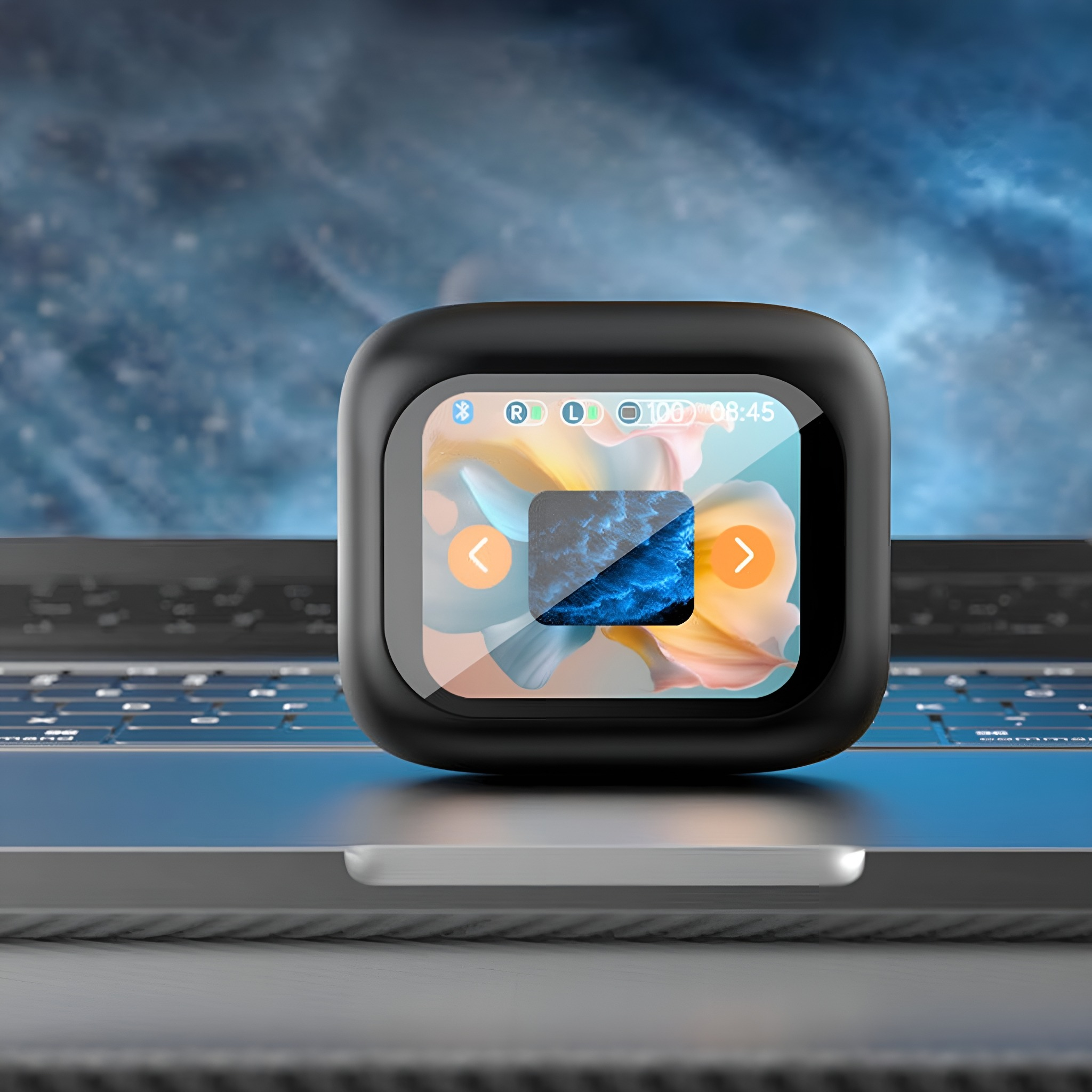 Schwarzes, quadratisches Gerät auf einem Laptop. Der Bildschirm zeigt ein farbenfrohes Bild. Gerät mit Bildschirm und Knöpfen.