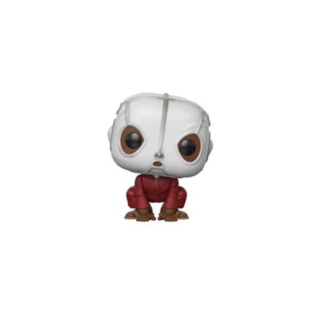 Una pequeña figura de un personaje con cabeza blanca y atuendo rojo, en posición agachada.