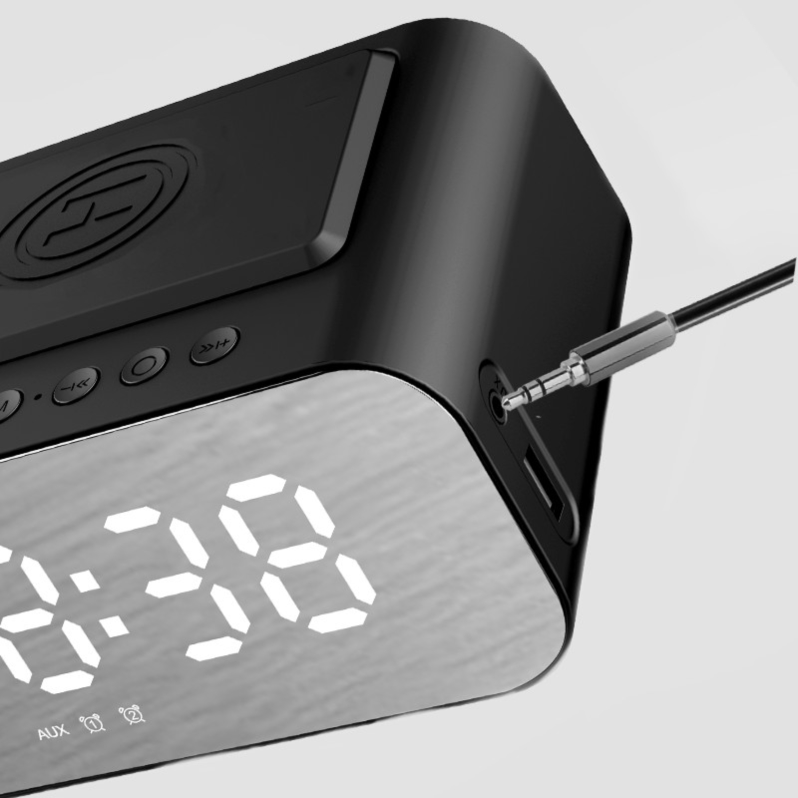 Ein schwarzes digitales Radiowecker mit einem Kabel, das in die Seite gesteckt ist.