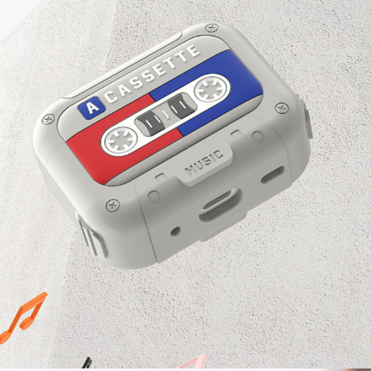 Caja gris en forma de casete, con detalles rojos, azules y la palabra casete.