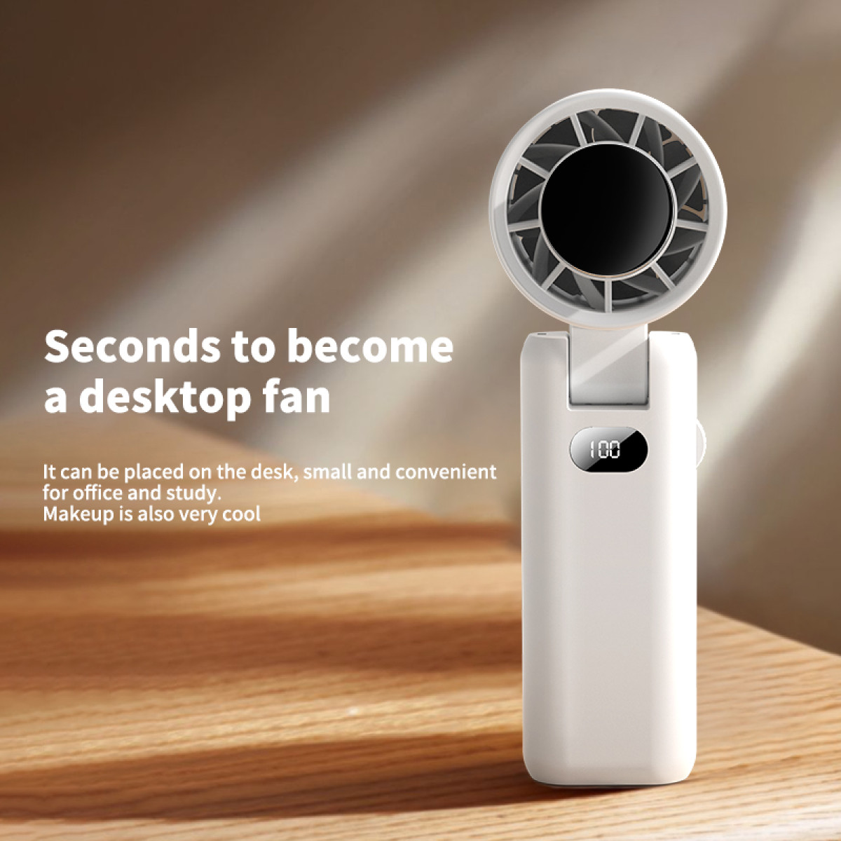 White handheld fan with display showing 100, on a wooden desk. White background.