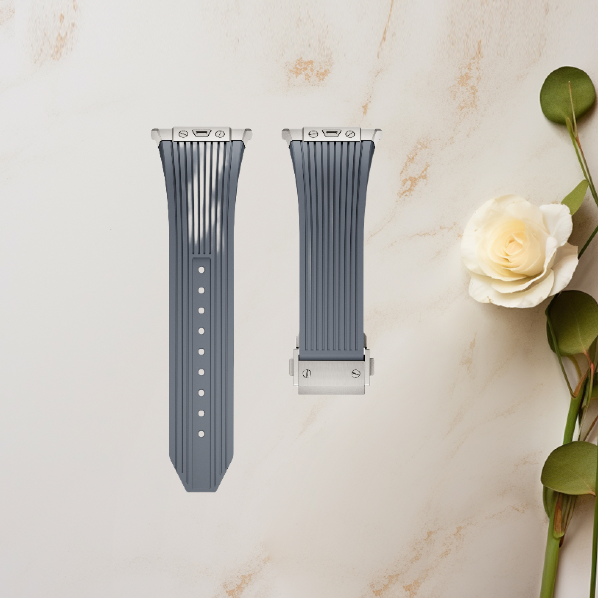 Due cinturini grigi per smartwatch con una rosa e foglie sullo sfondo.
