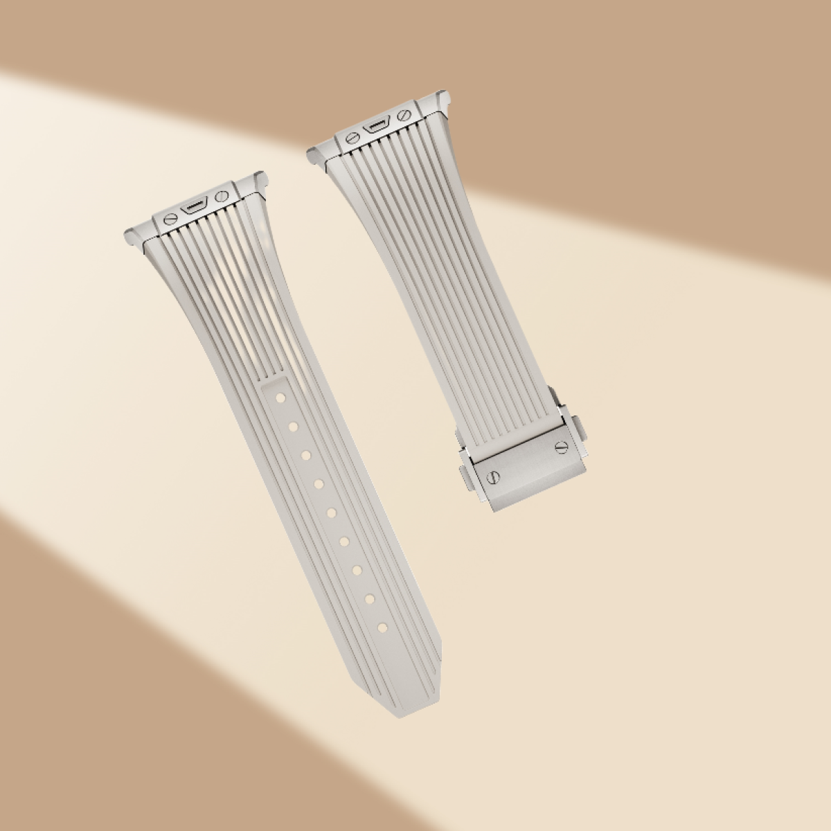 Due cinturini per orologi color argento, con un design a coste, su uno sfondo marrone chiaro.
