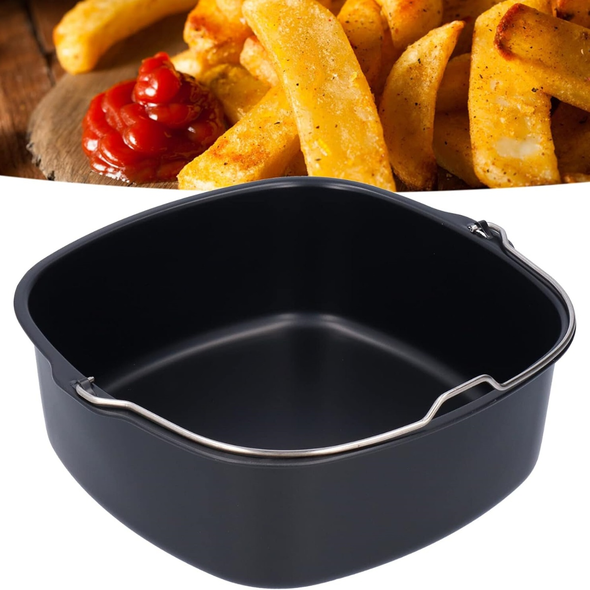 Ein Airfryer-Korb mit Pommes Frites und Ketchup im Hintergrund.