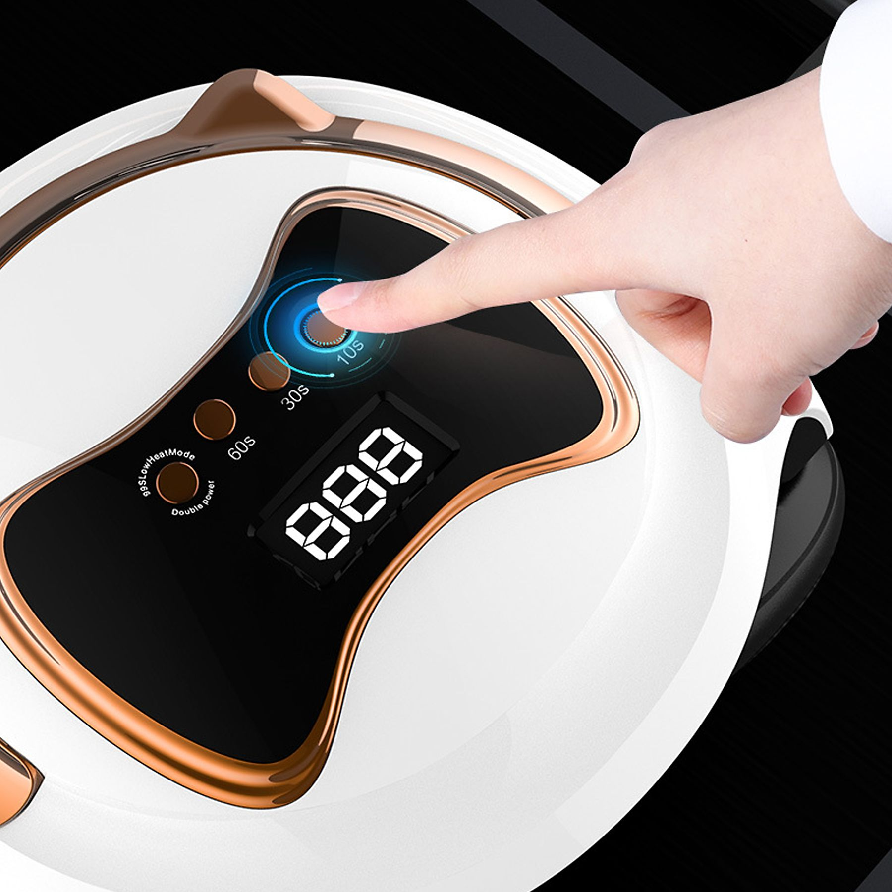 Eine Hand drückt einen Knopf auf einem Nageltrockner. Der Trockner ist weiß mit goldfarbenem Besatz. Es gibt eine Digitalanzeige.