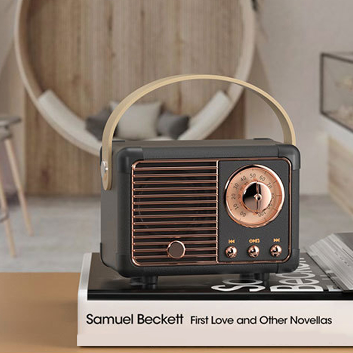 Schwarzes und bronzefarbenes Retro-Radio auf einem Buch. Holzgriff. Hintergrund unscharf.