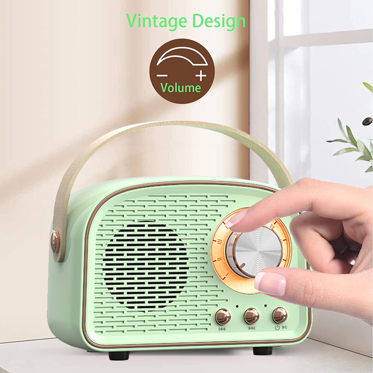 Ein mintgrünes Retro-Radio mit Griff. Eine Hand dreht den Lautstärkeregler. Oben steht Vintage Design.