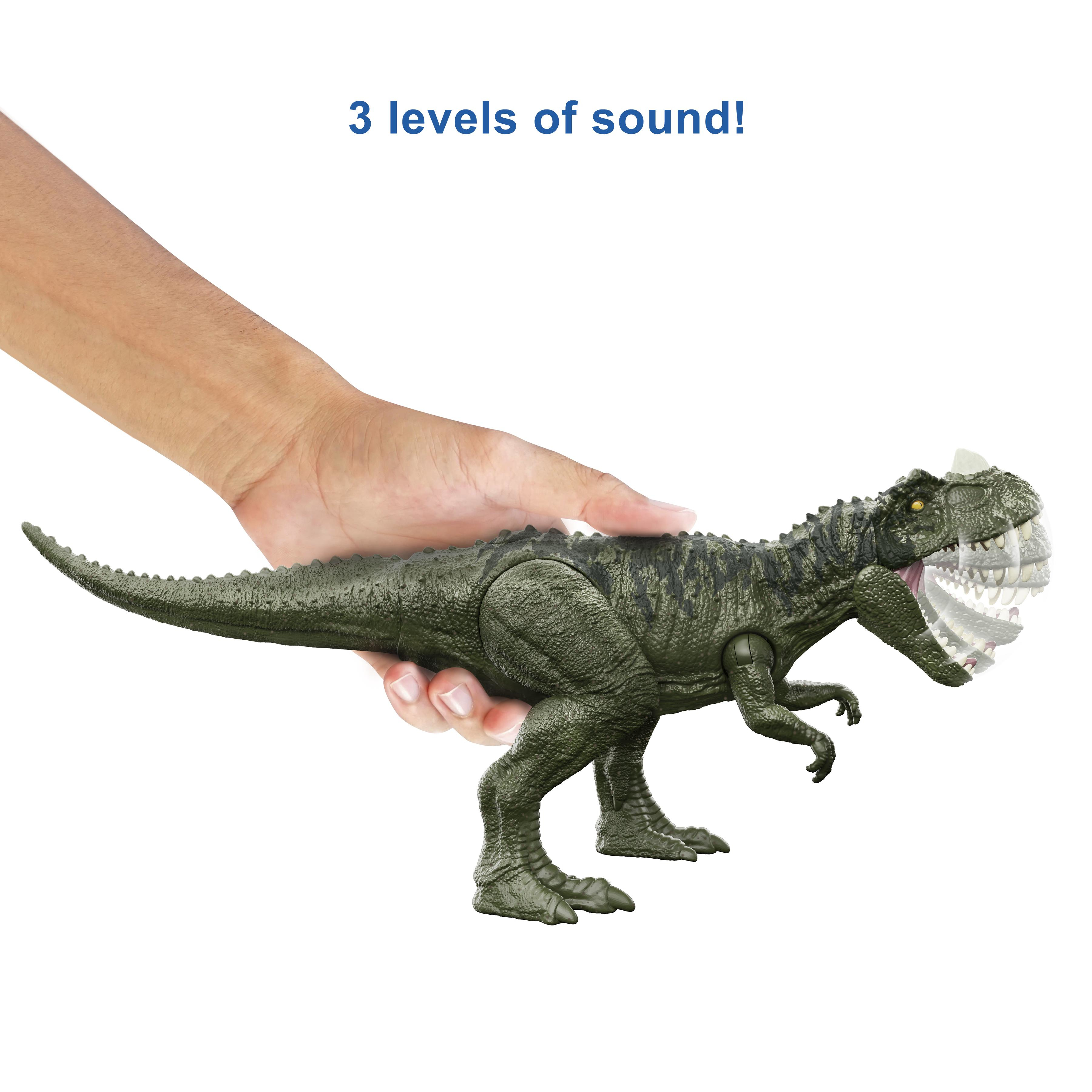 Ręka trzymająca zieloną zabawkę dinozaura. Tekst mówi '3 levels of sound!'.