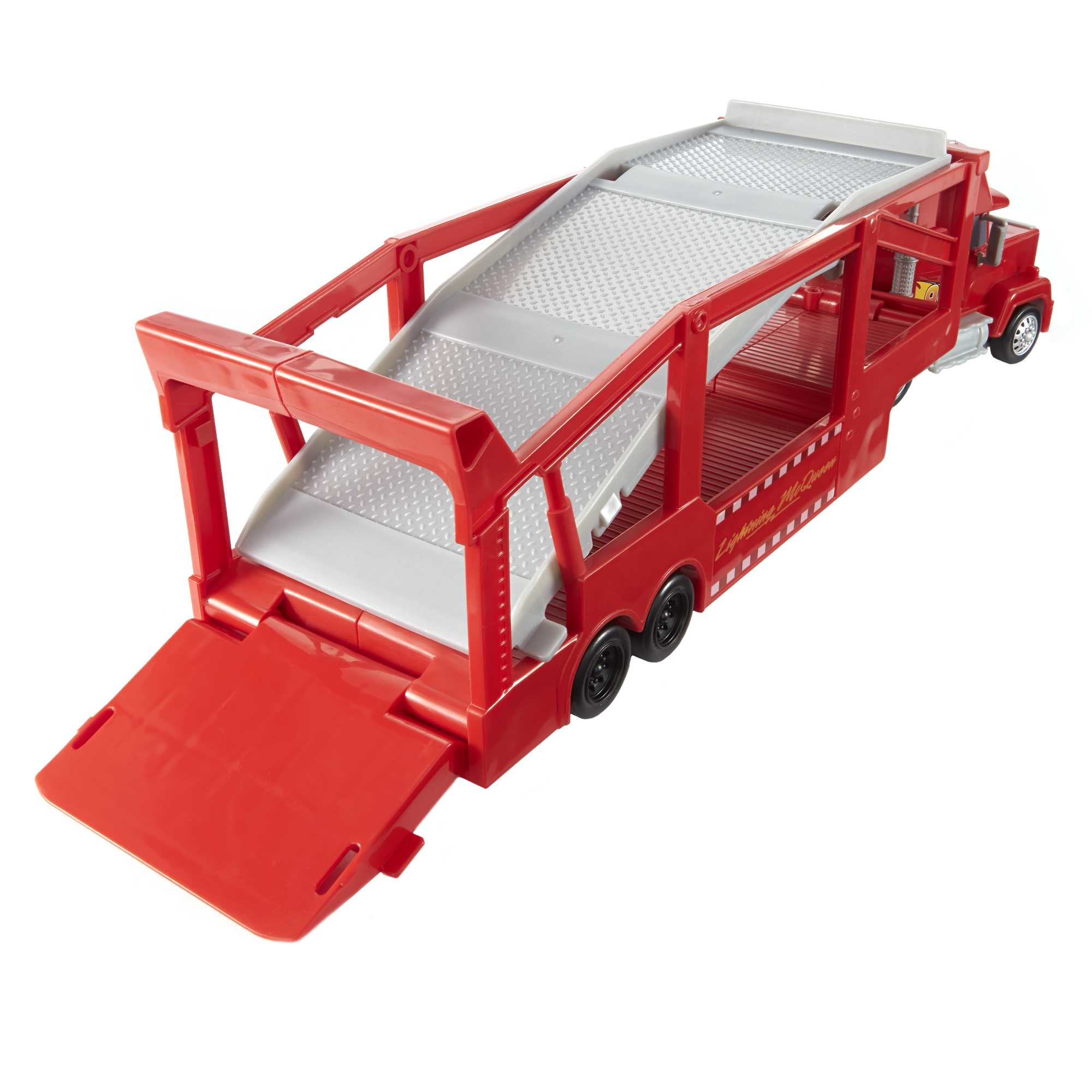 Roter Spielzeug-LKW mit ausfahrbarer Rampe und weißem Hintergrund.
