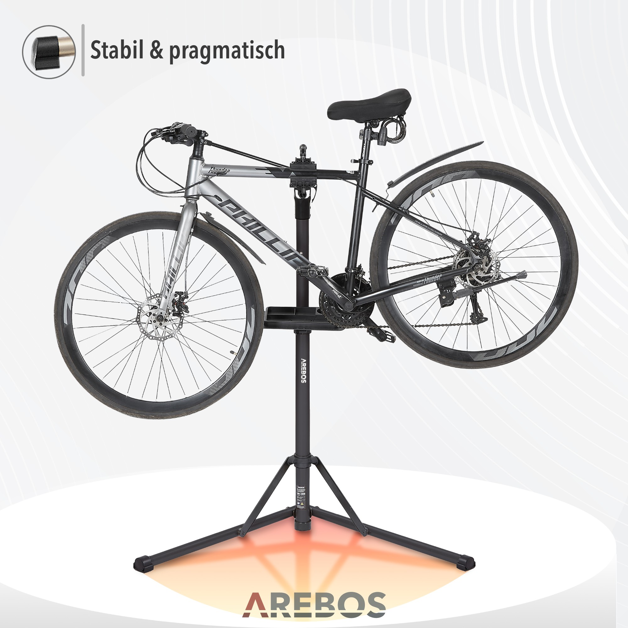 Fahrrad auf einem Reparaturständer montiert. Der Text lautet 'AREBOS' und 'Stabil & pragmatisch'.