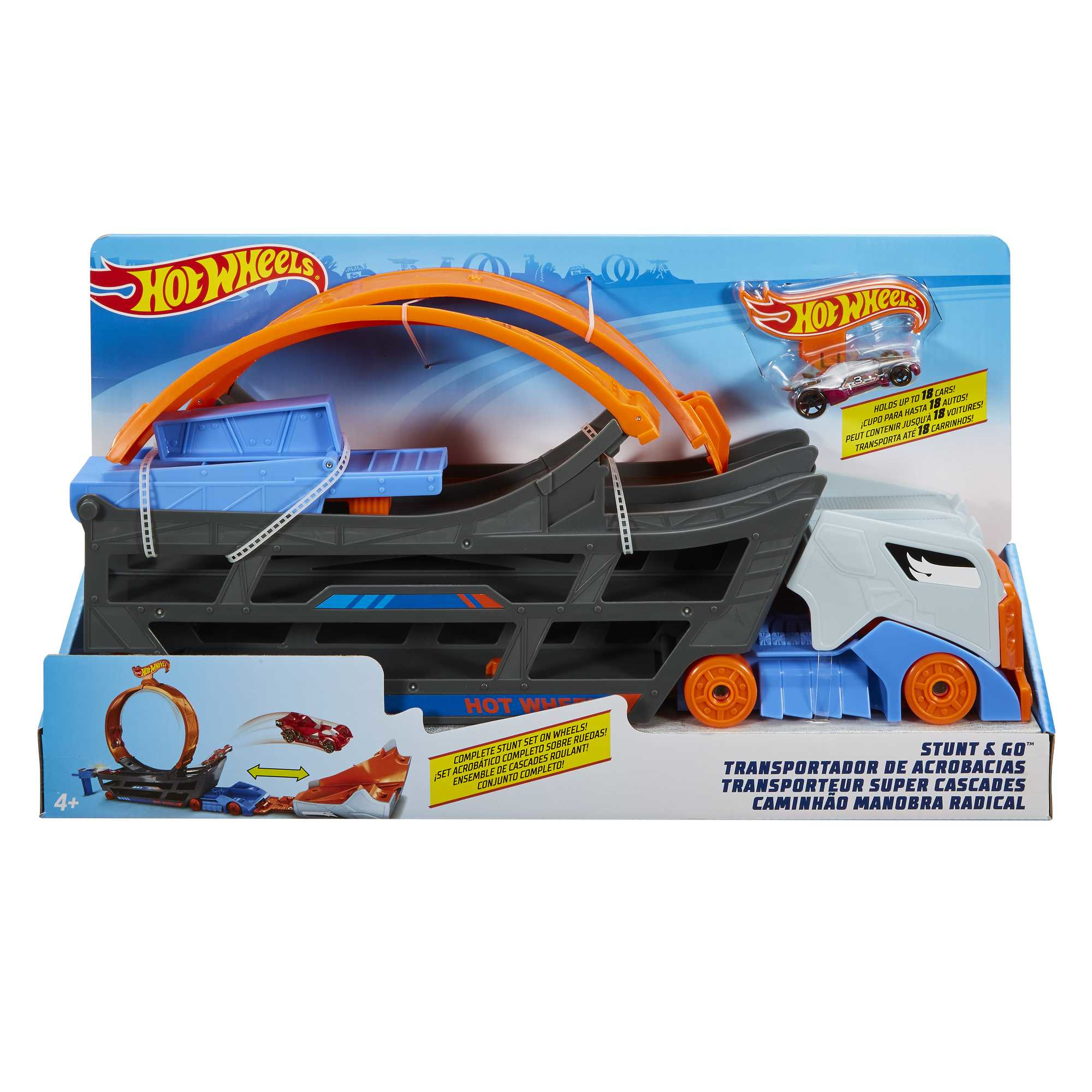Coffret de circuit Hot Wheels avec un grand camion, une boucle orange et des voitures sur fond blanc.
