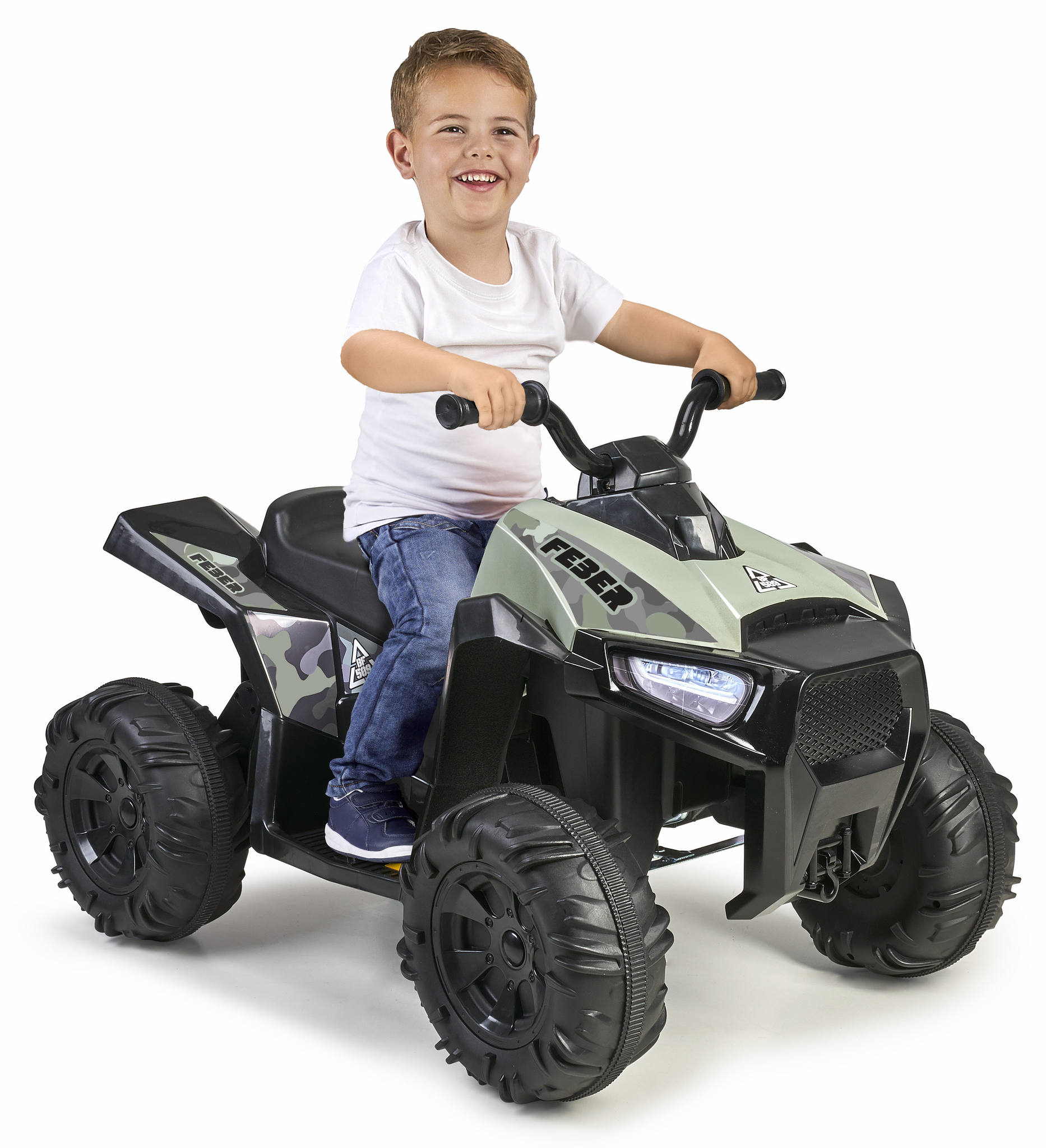 Un niño en un quad de juguete verde y negro sonriendo. Fondo blanco.