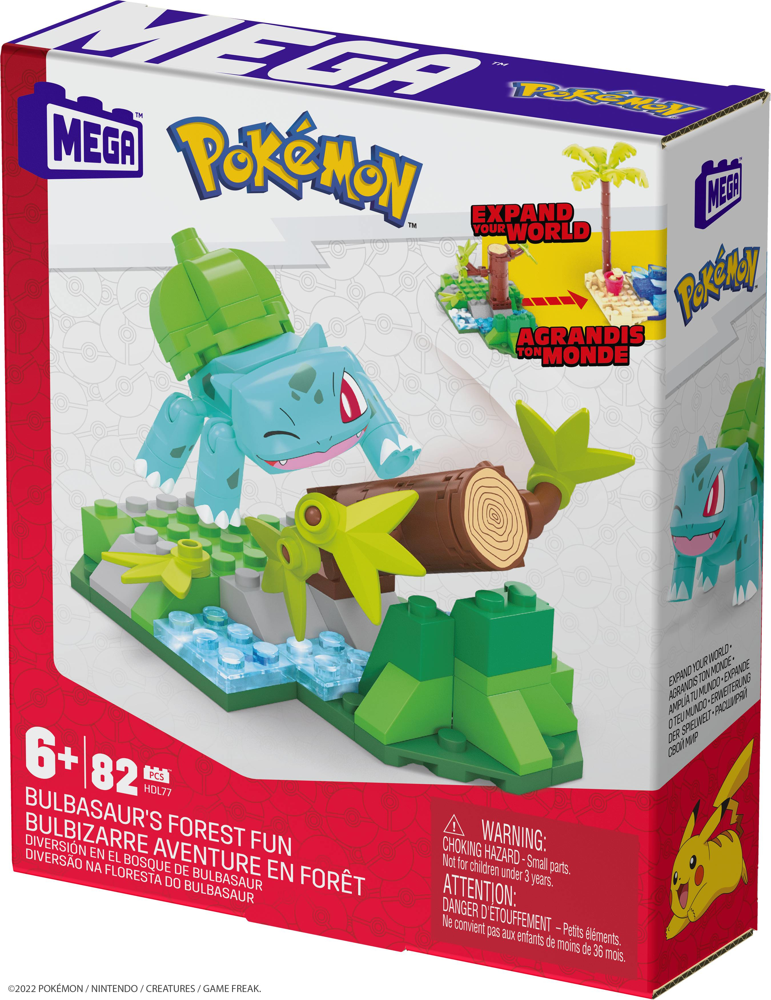 Bulbasaur-Spielzeugset auf grüner Basis, mit Box und Palme rechts.